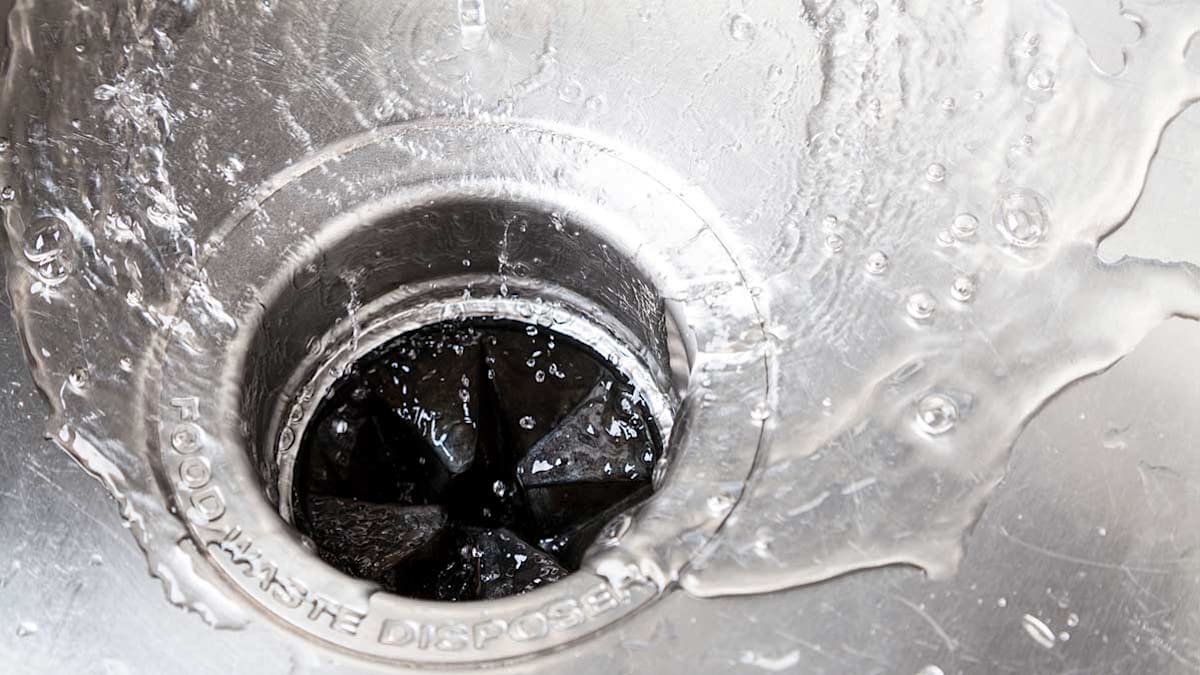Water rushing down a sink drain.