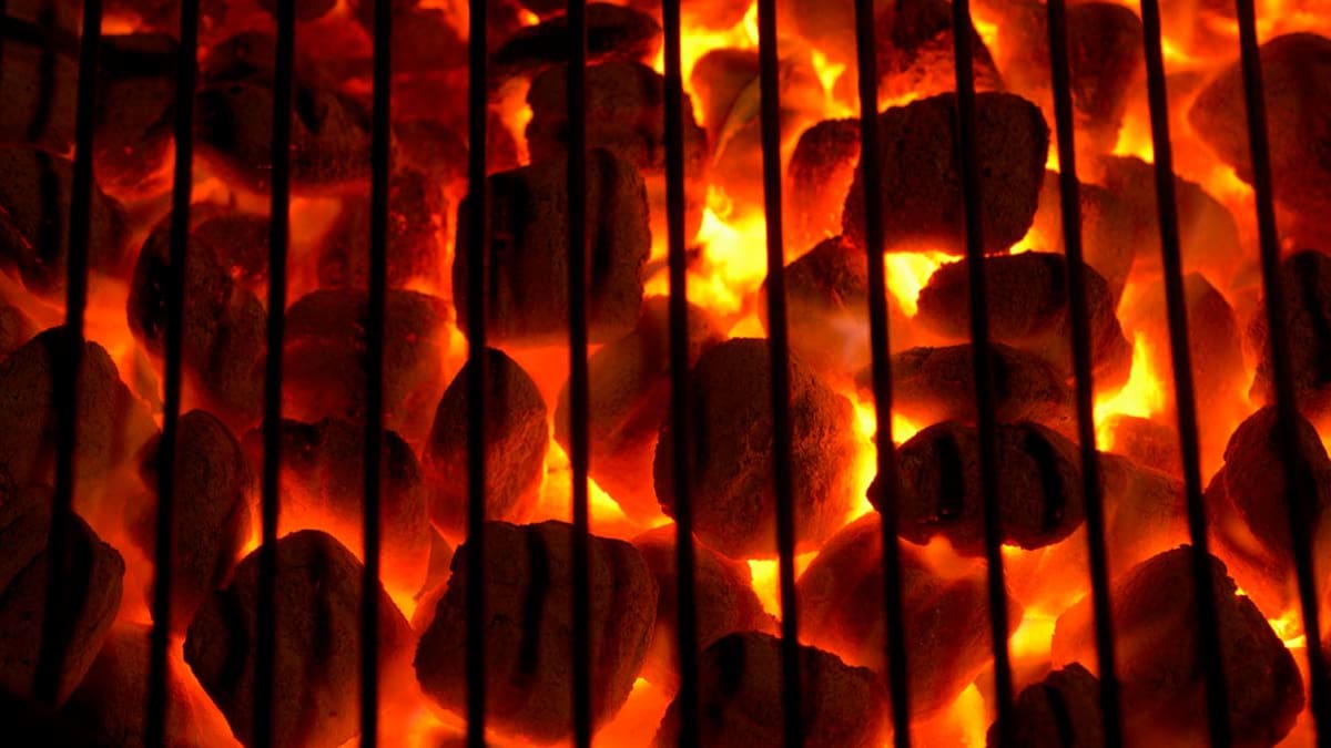 Red hot coals underneath a grill
