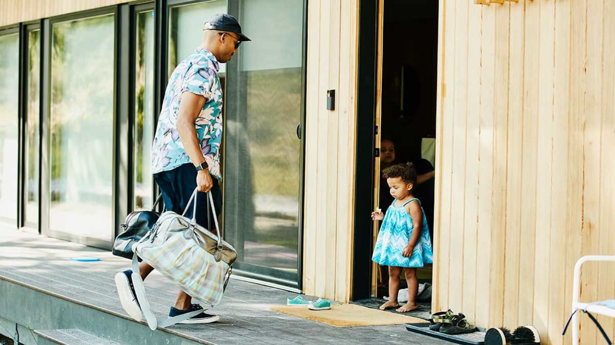 person entering vacation rental with luggage