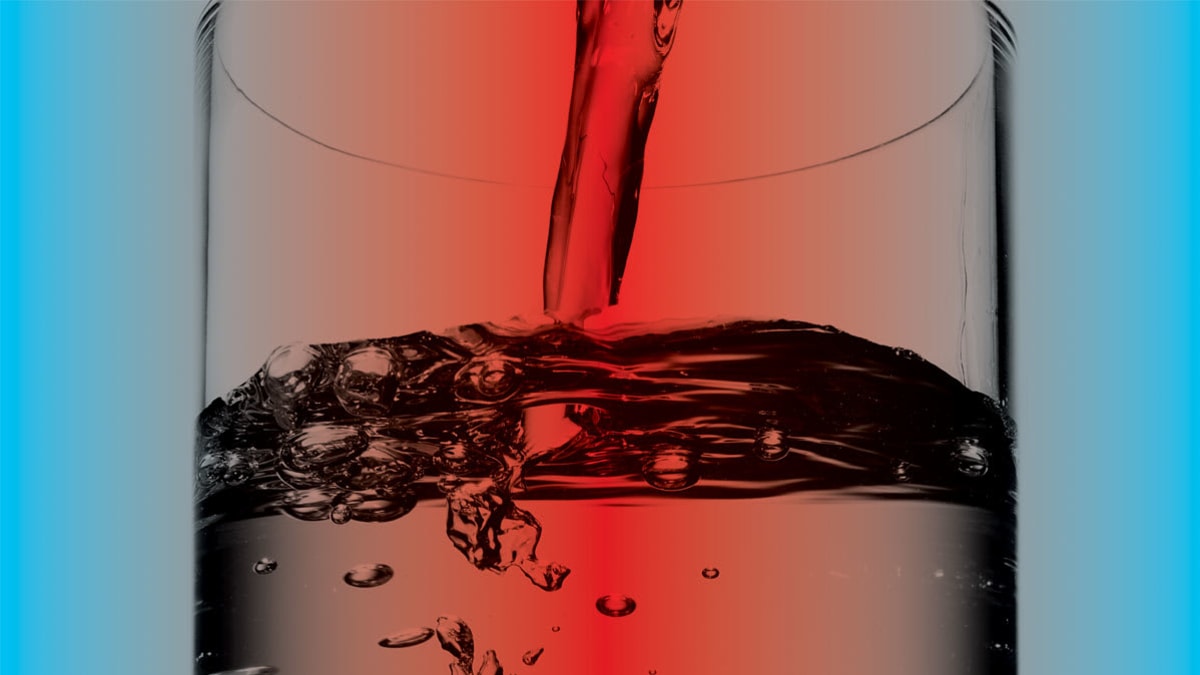 Close up of water being poured into a glass.