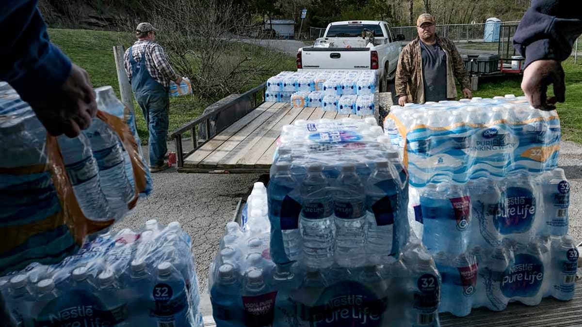 People pick up donated water to share with Martin County community members in Huntleyville, Ky., on April 1, 2019. Photograph: Bonnie Jo Mount/The Washington Post via Getty Images