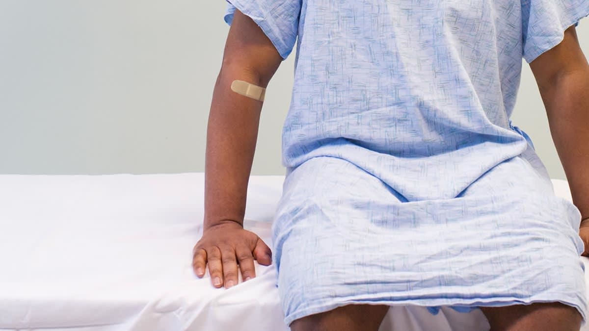 Black person in hospital gown