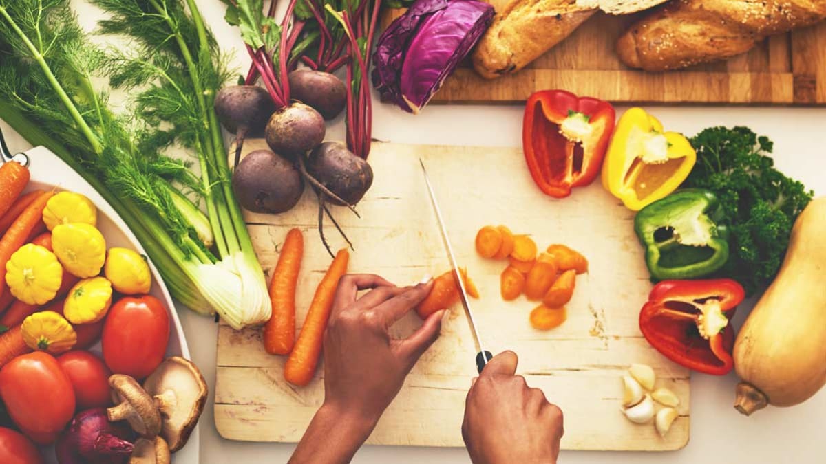 person cutting veggies, food prep, whole foods