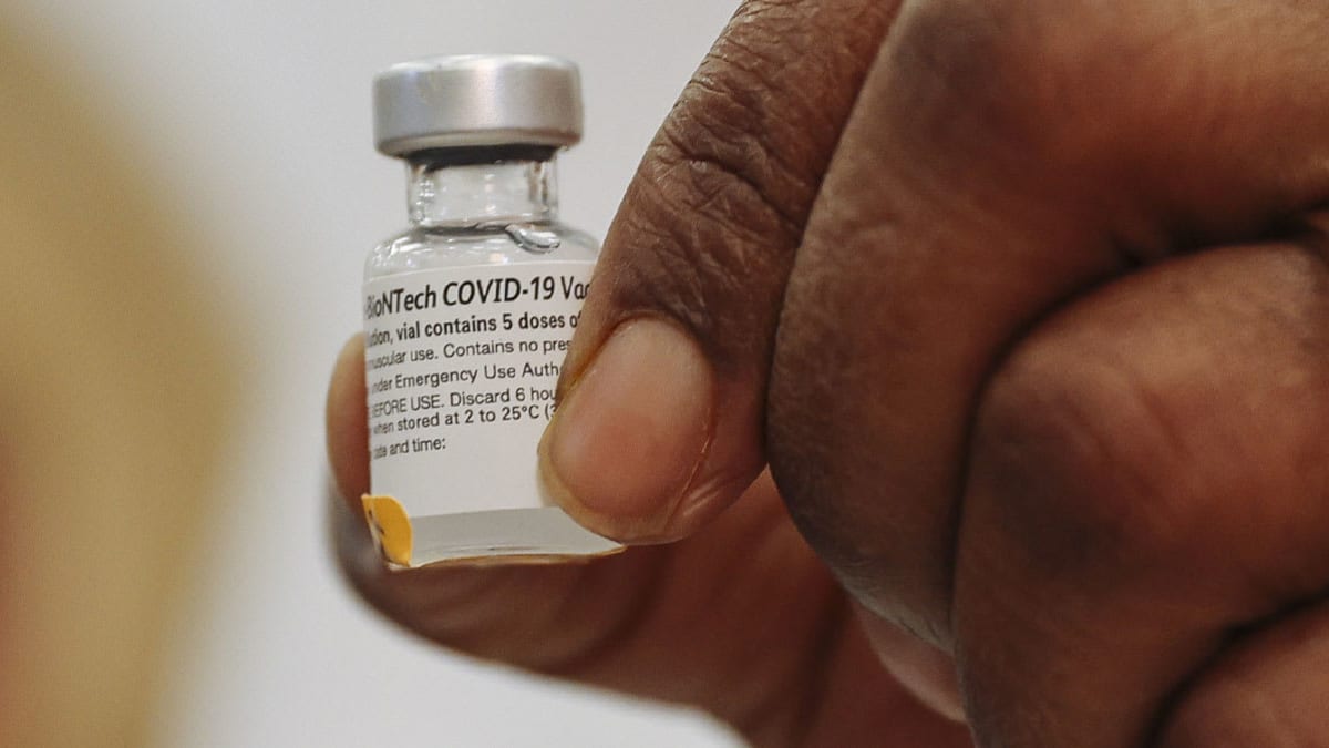Covid 19 vaccine vile in hand