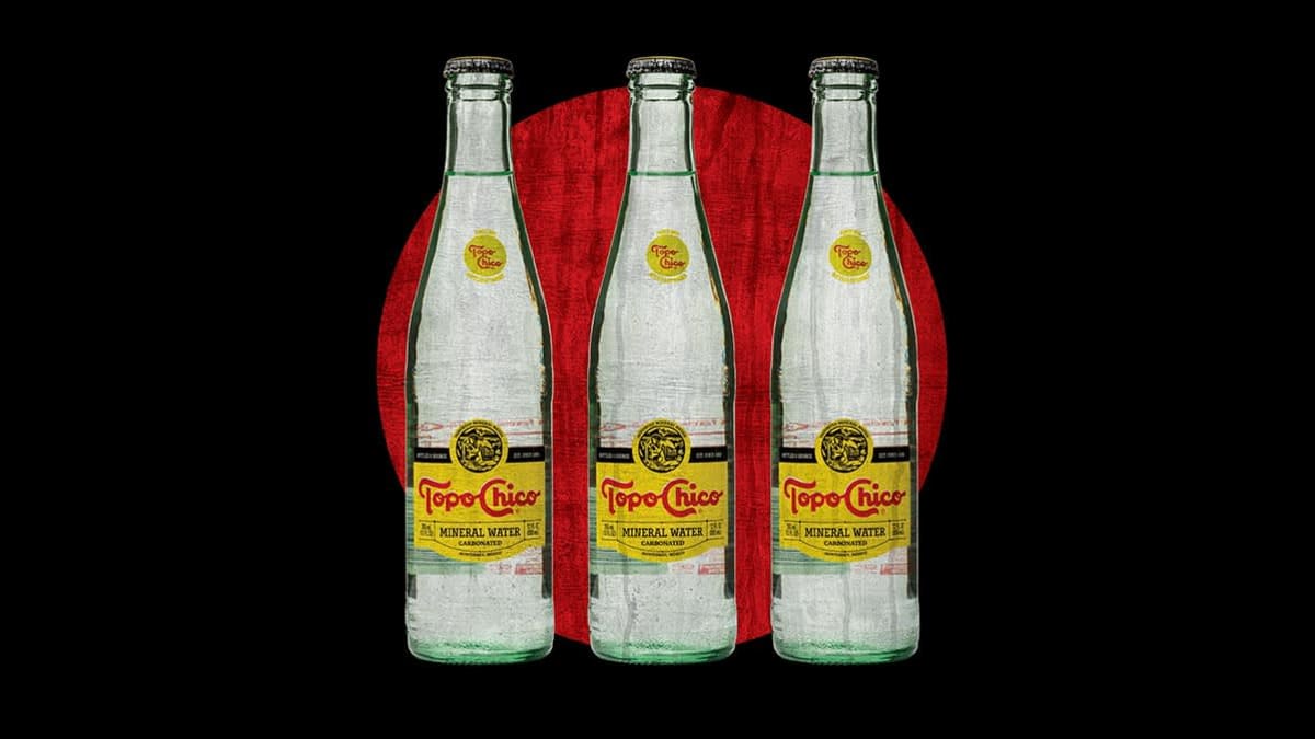 Illustration of three bottles of Topo Chico lined up on black and red background