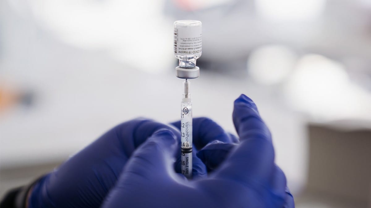A healthcare worker prepares a dose of the Pfizer-BioNTech Covid-19 Vaccine at a mass vaccination site at The Forum arena in Inglewood, California, U.S., on Friday, Feb. 26, 2021.