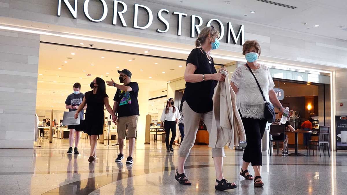 A number of shoppers wearing face masks leaving a Nordstrom inside a Chicago shopping mall.