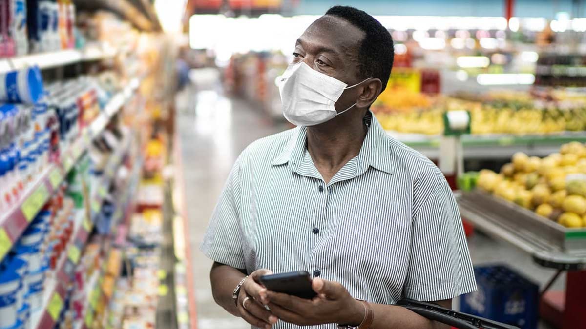Person shopping in a grocery store wearing a face mask.