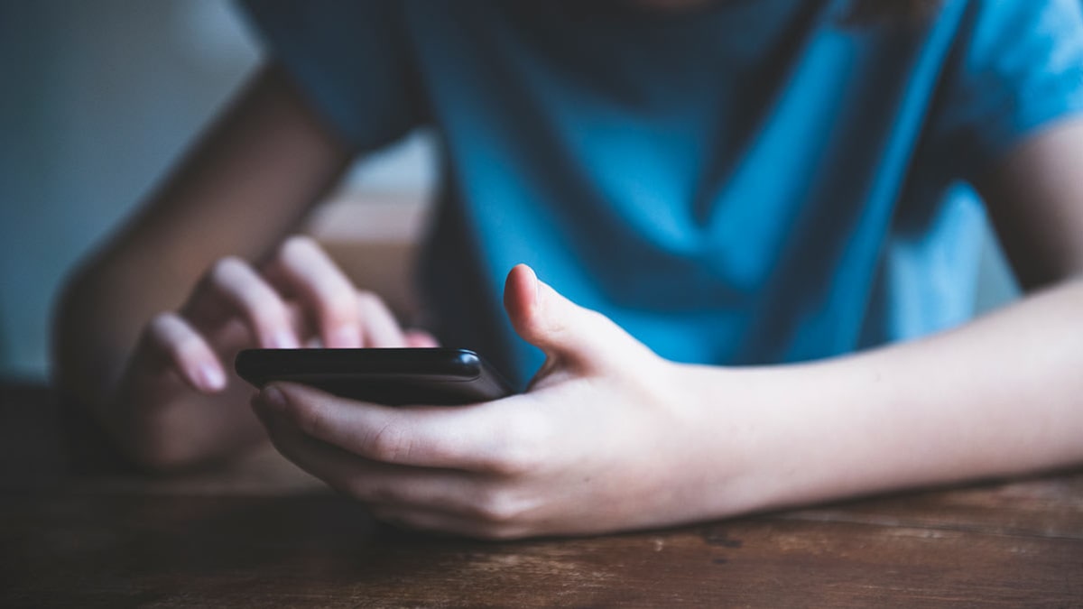 Teenager using a cell phone.