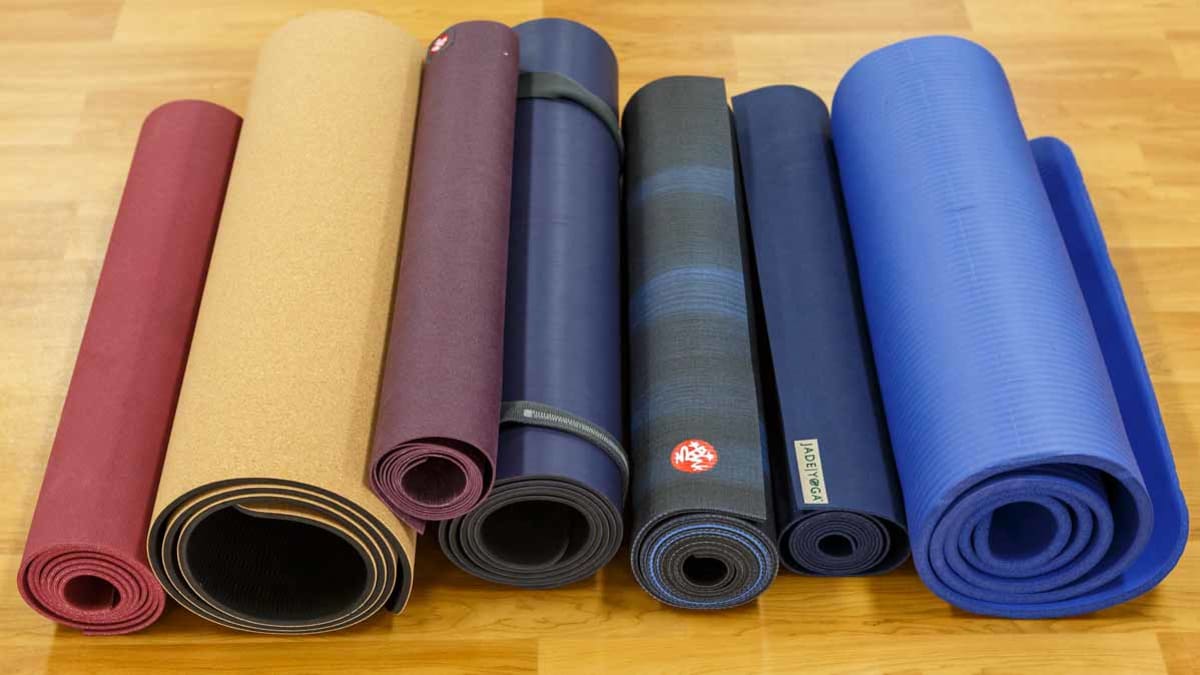 Different types of yoga mats on gym floor