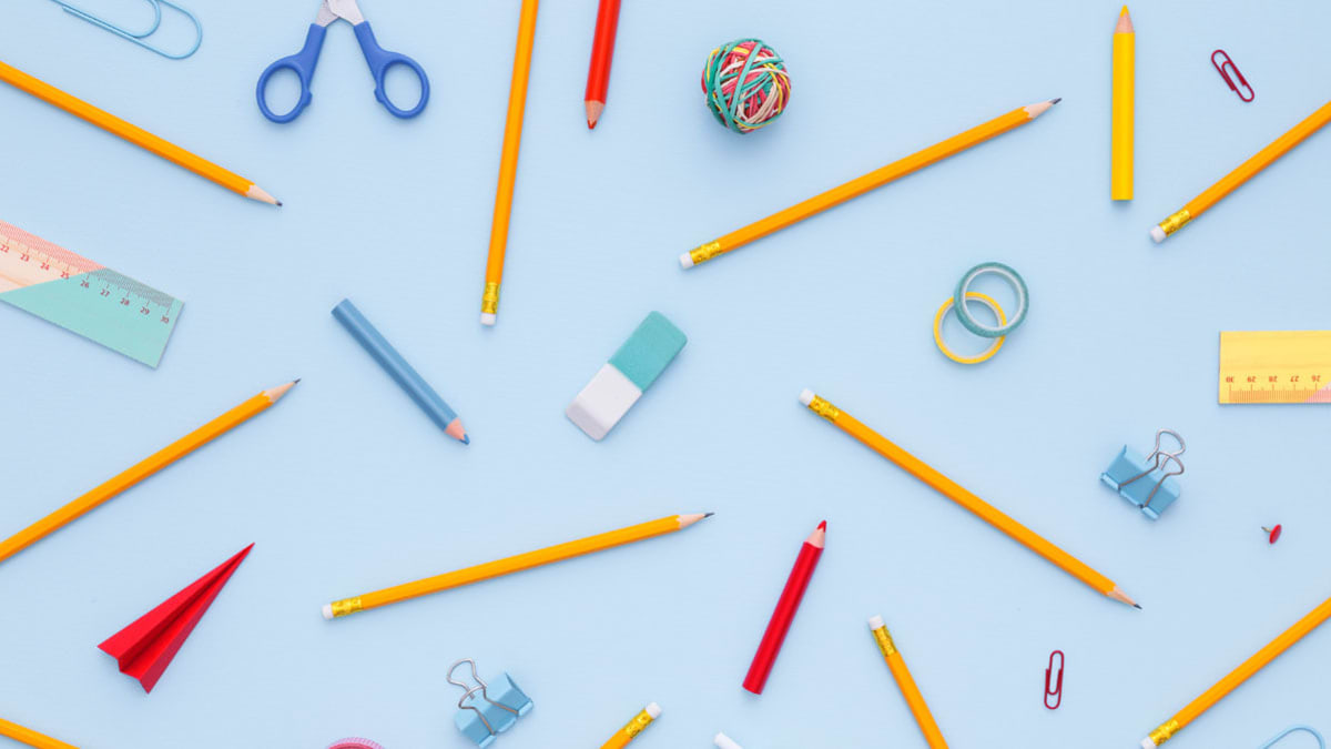 Misc school supplies in a pattern against a blue background