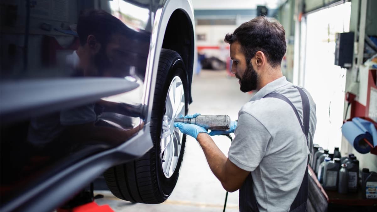 Mechanic putting a new tire on a car