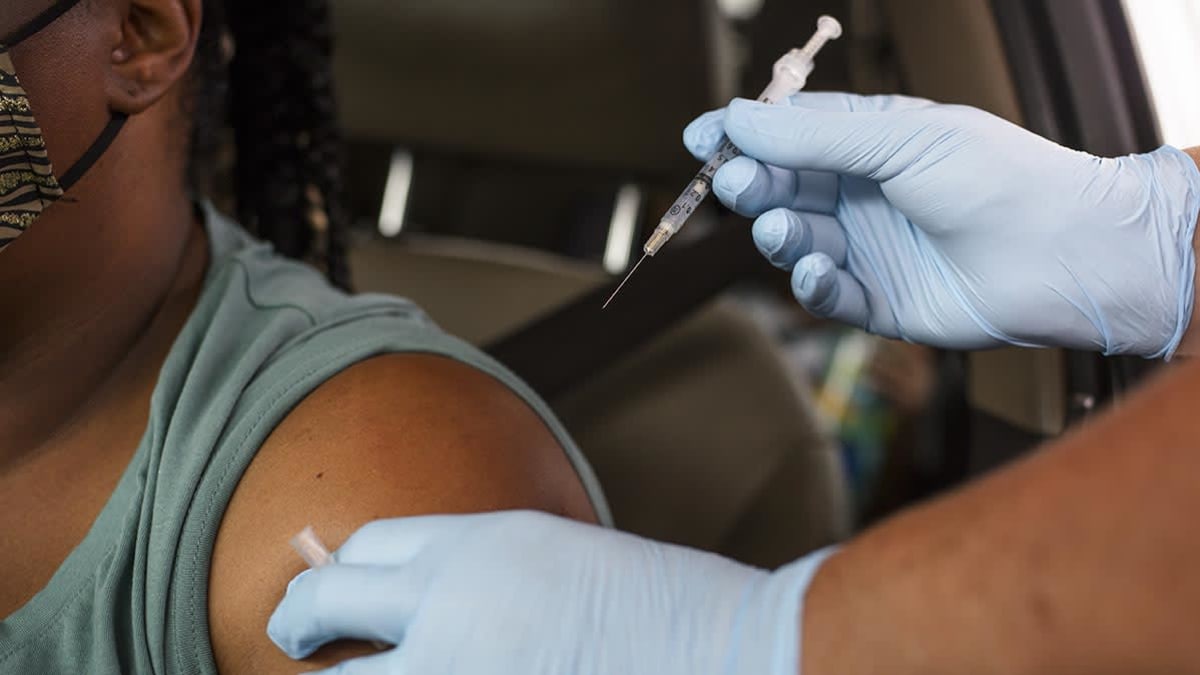 A healthcare worker administers a Covid-19 vaccine at the Austin Regional Clinic drive-thru vaccination and testing site in Austin, Texas, U.S., on Thursday, Aug. 5, 2021.
