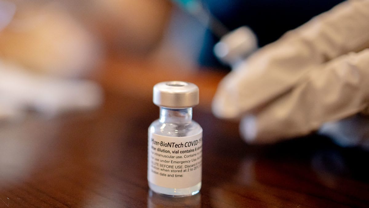 A healthcare worker prepares Pfizer-BioNTech Covid-19 vaccines for third doses at a senior living facility in Pennsylvania.
