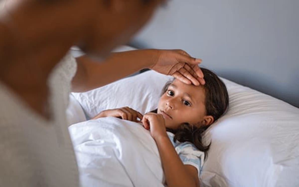 Parent tending to their sick child.