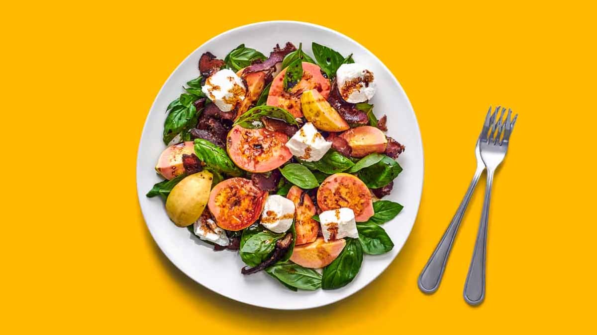 salad on white plate with forks on side