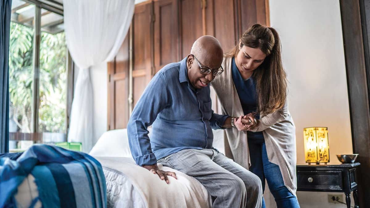 aid helping person get out of bed