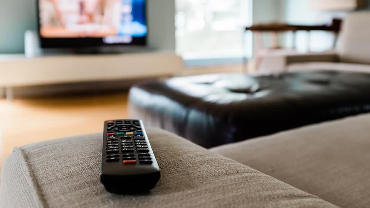 Remote control sitting in front of a television