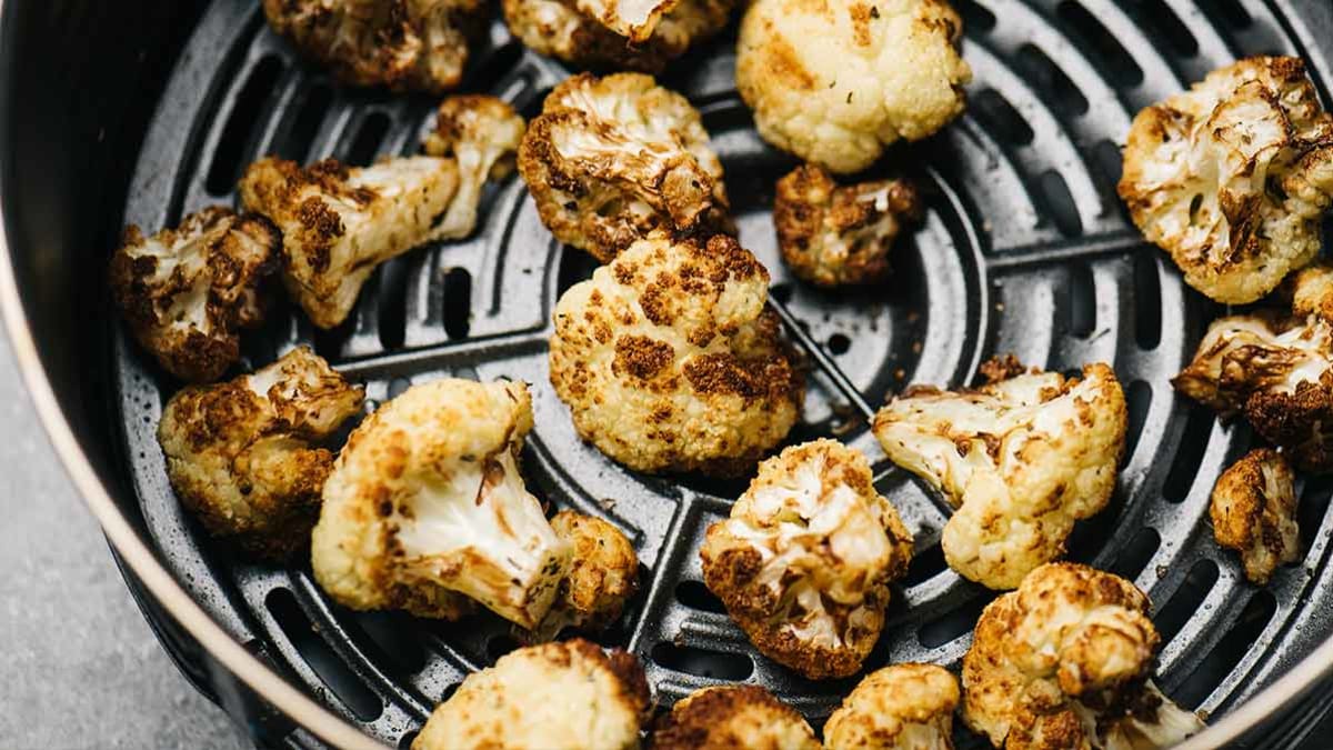 Cauliflower cooking in an air fryer.