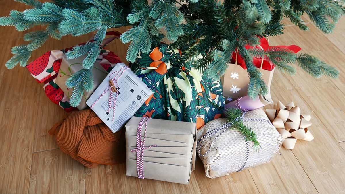Christmas tree with eco-wrapped gifts underneath.