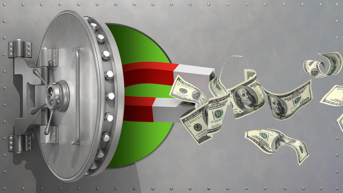 Vault with magnet attracting hundred dollar bills