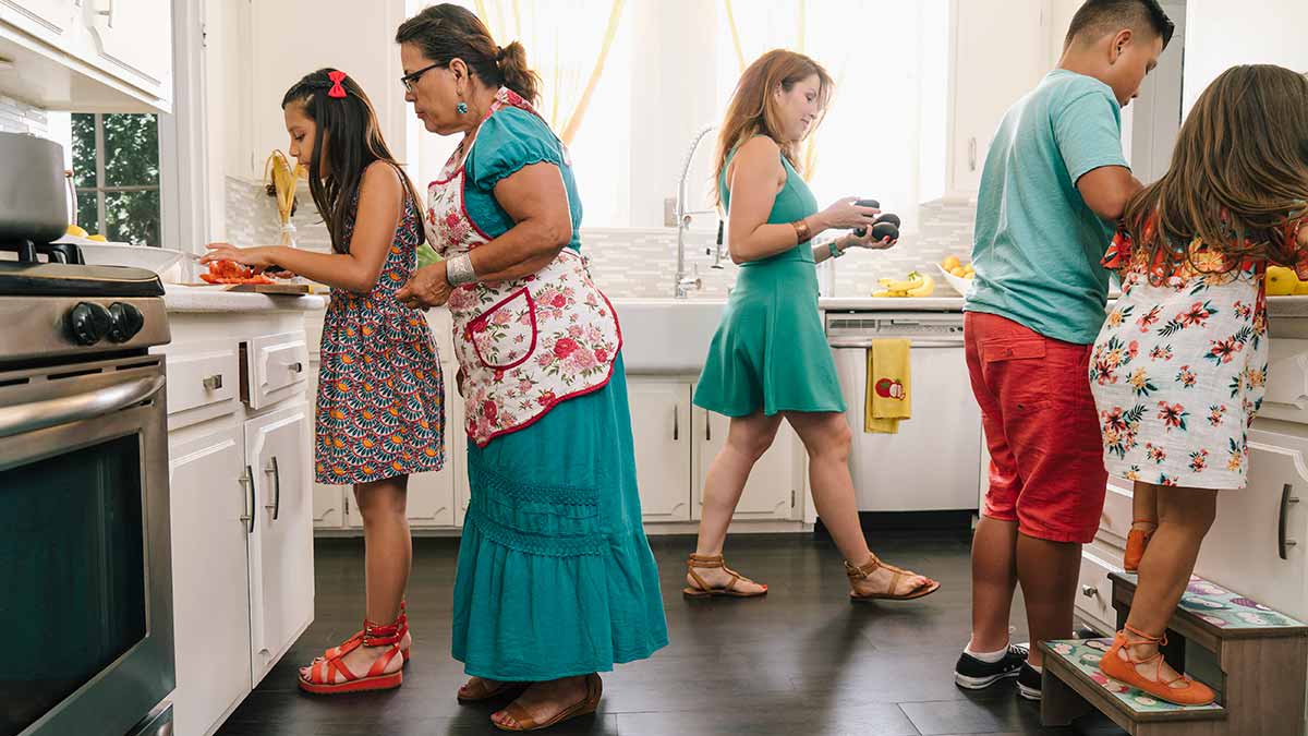 Grandmother, mother and children cooking in a home kitchen