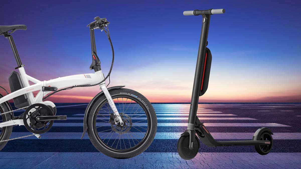 E-bike and scooter on Asphalt road against skyline at night background