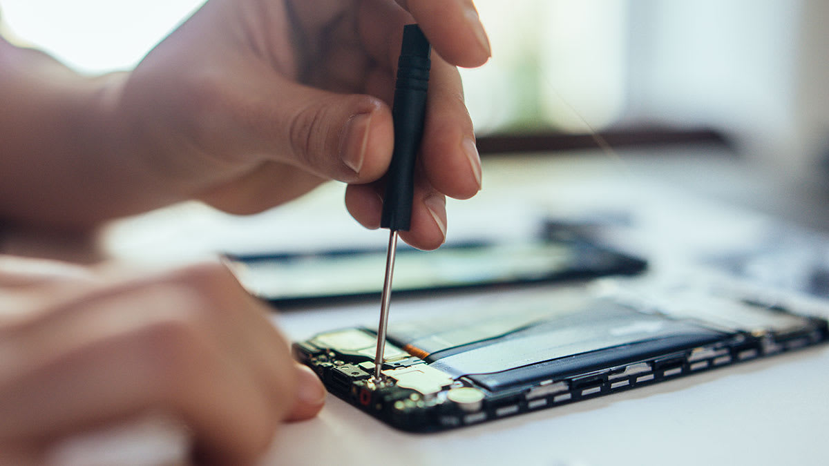 Person repairing their cell phone
