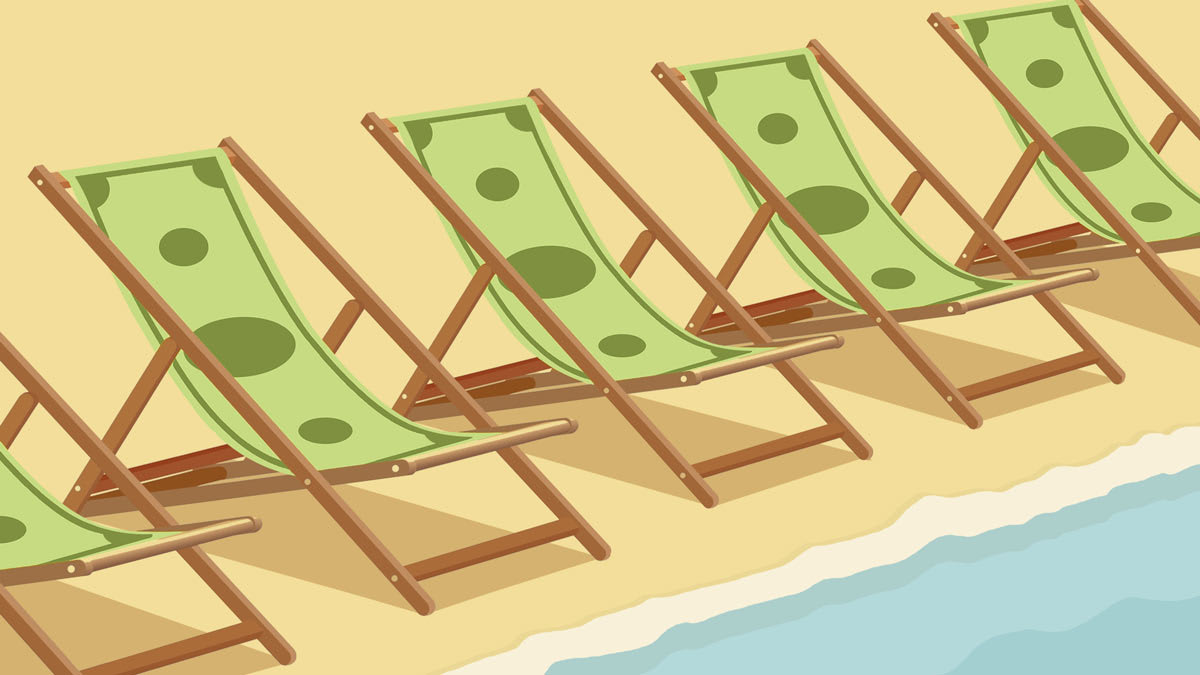Beach chairs lined up close to the ocean with fabric made from $ bills