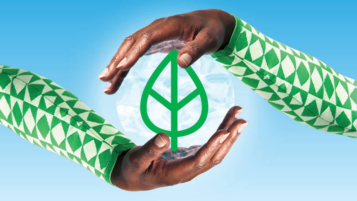Hands surrounding green leaf icon