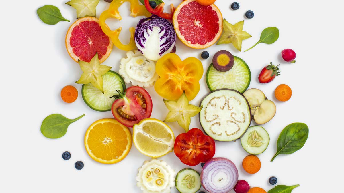 overhead view of collage of various slices of fruit and vegetables