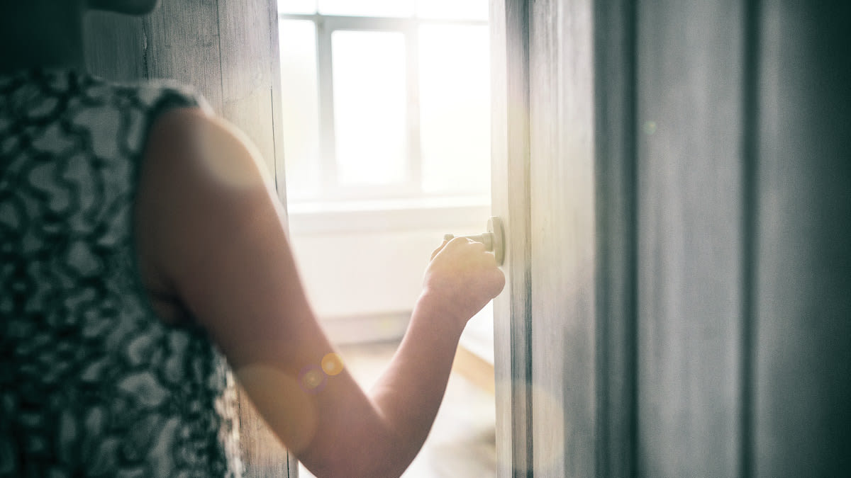 A woman walking through a door