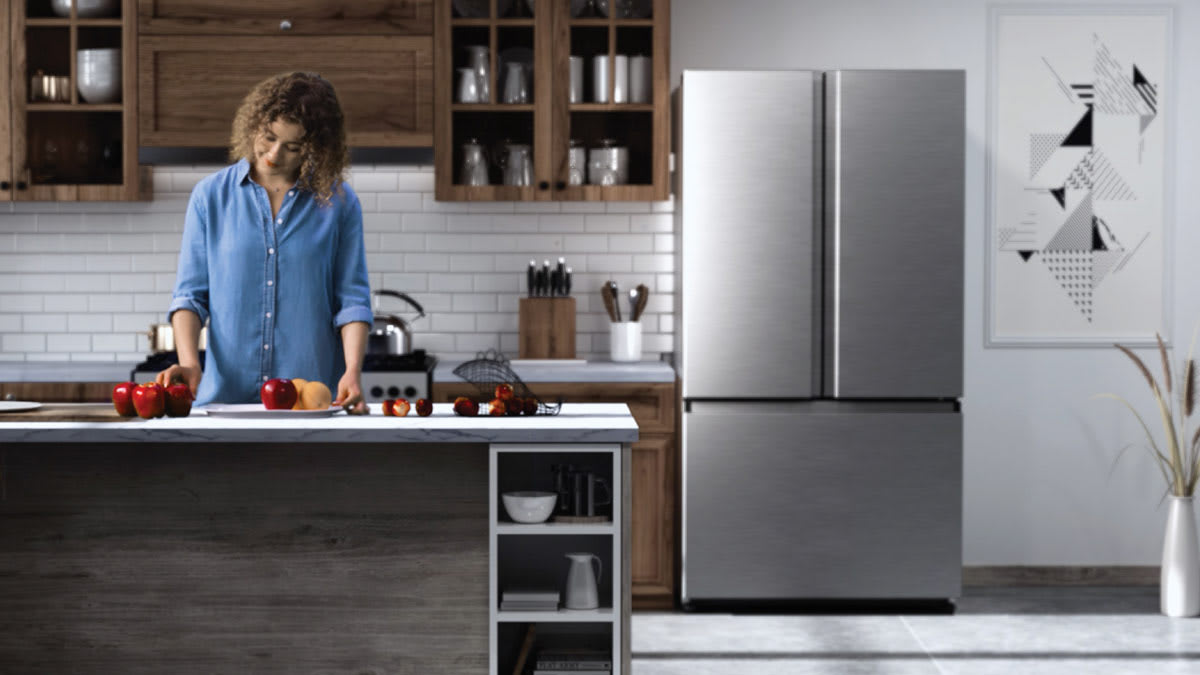 Hisense HRF266N6CSE1 refrigerator in kitchen with person at island sorting apples and oranges