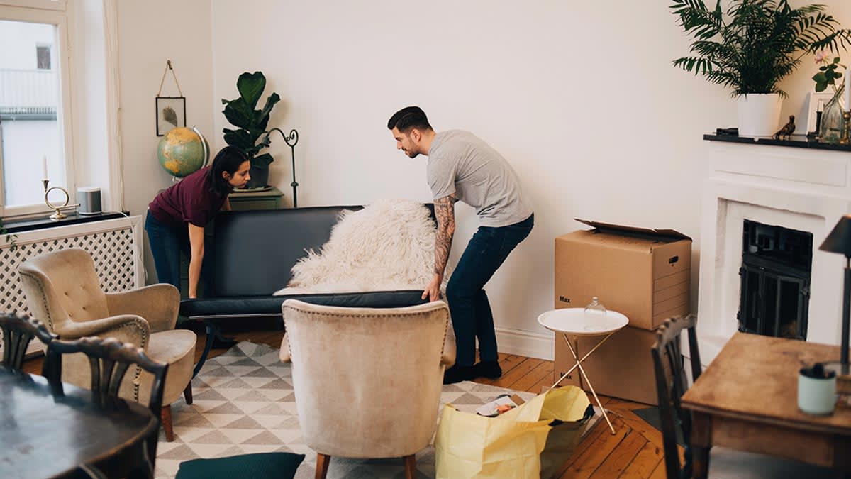 Couple arranging furniture in their living room