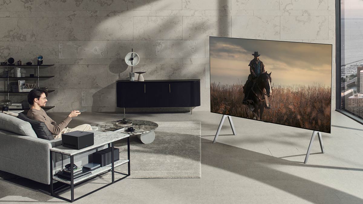 person sitting on couch in living room in front of LG TV