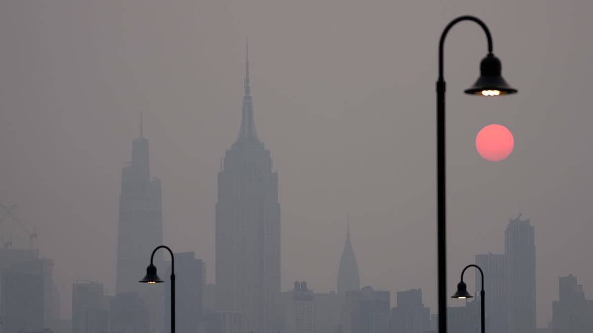 The sun rises over a hazy New York City skyline as seen from Jersey City, N.J., Wednesday, June 7, 2023. Intense Canadian wildfires are blanketing the northeastern U.S. in a dystopian haze, turning the air acrid, the sky yellowish gray and prompting warnings for vulnerable populations to stay inside.