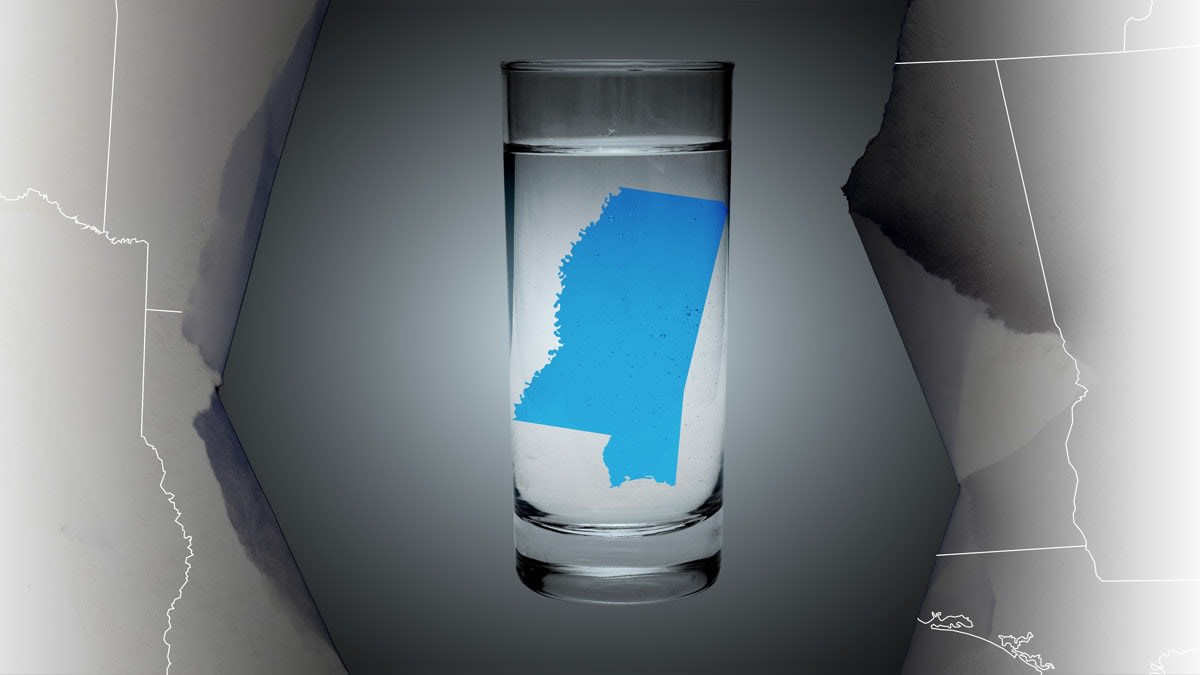 State of Mississippi in a water glass breaking through a map.