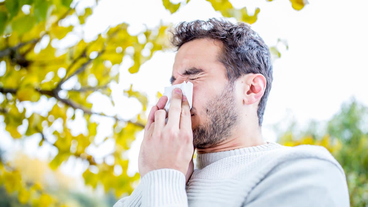A man blowing his nose.