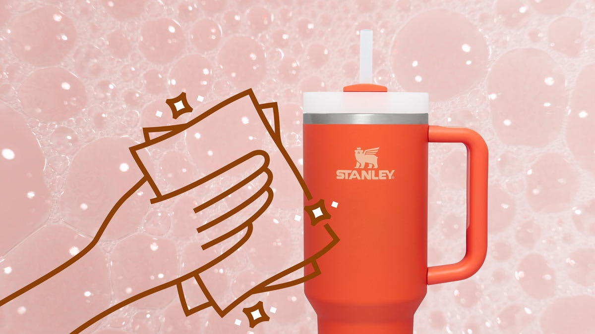 The Stanley Quencher H2.O FlowState™ Tumbler 40OZ on a background of soap bubbles with an illustration of hand cleaning with a cloth.