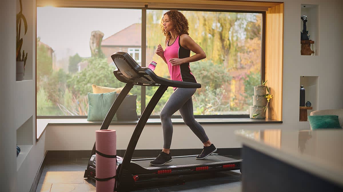 Person using a treadmill in their home.