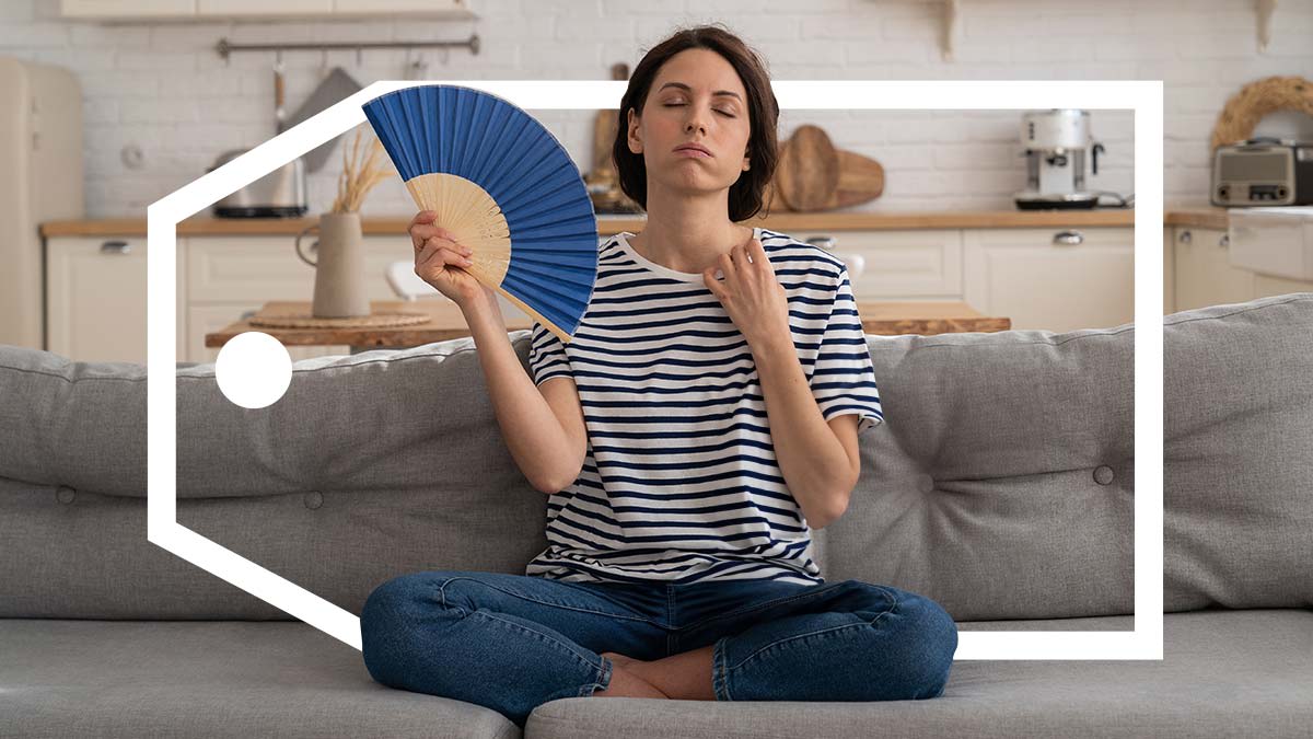 A woman sitting on the couch is fanning herself with a deal tag surrounding her.