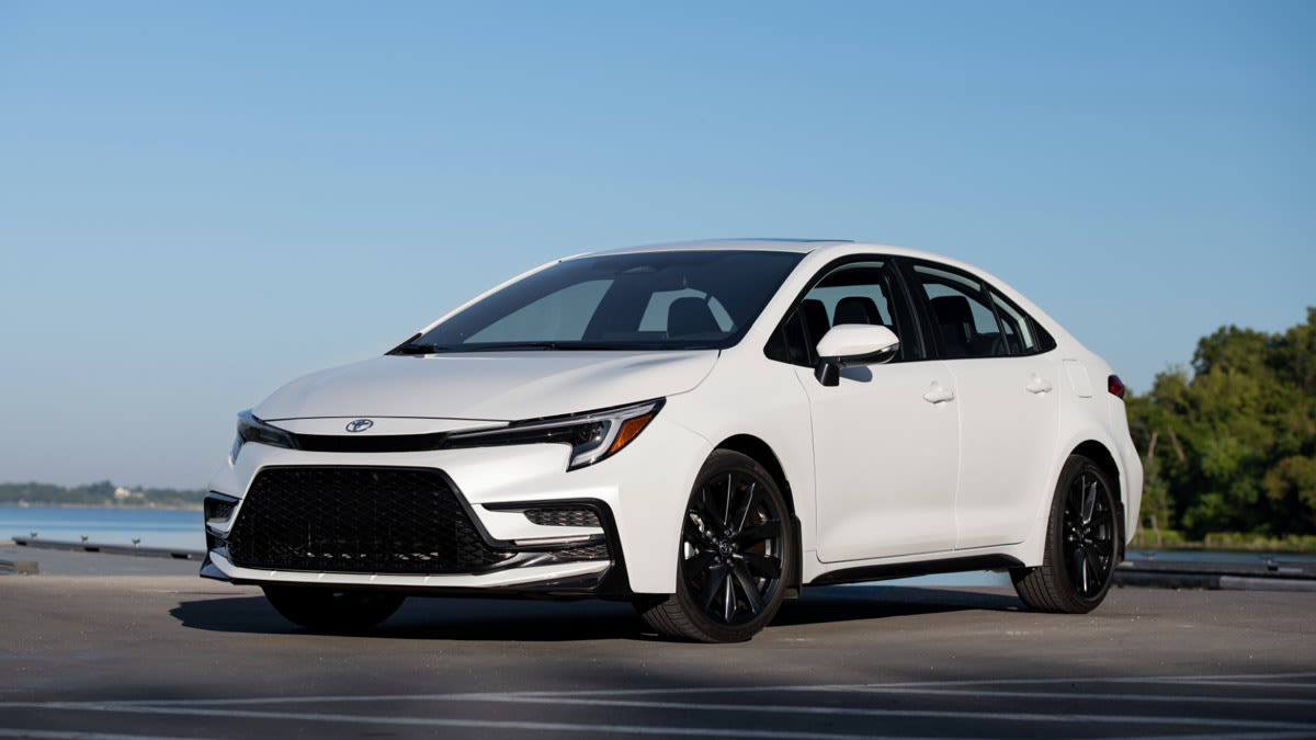 2024 Toyota Corolla in Pearl on asphalt with water and trees in background