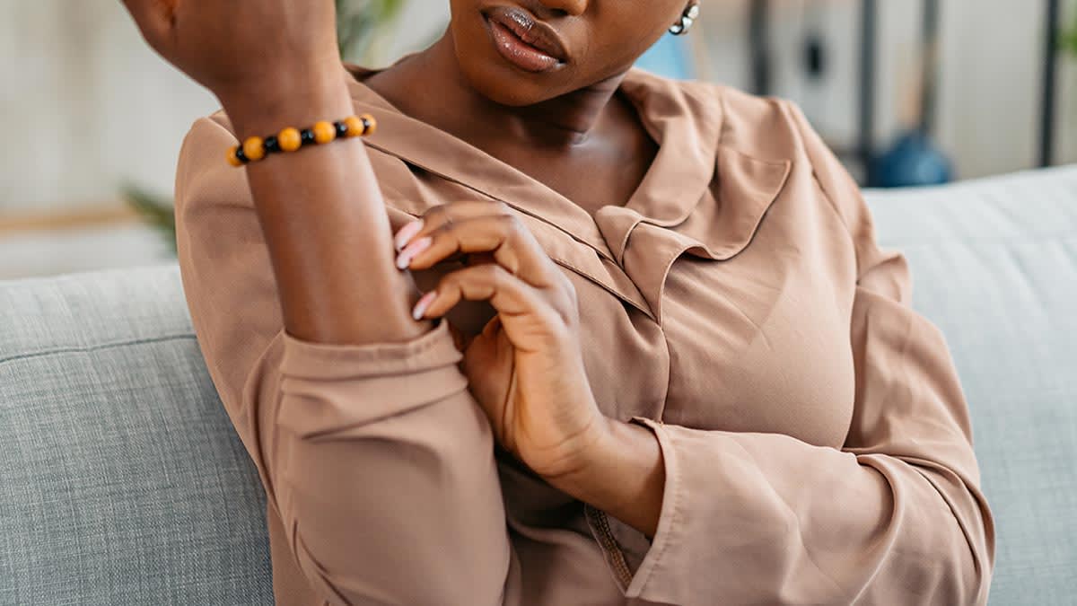 Woman scratching her arm