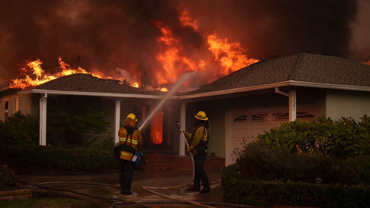 Firefighters battle flames from the Palisades Fire on January 8, 2025 in the Pacific Palisades neighborhood of Los Angeles, California