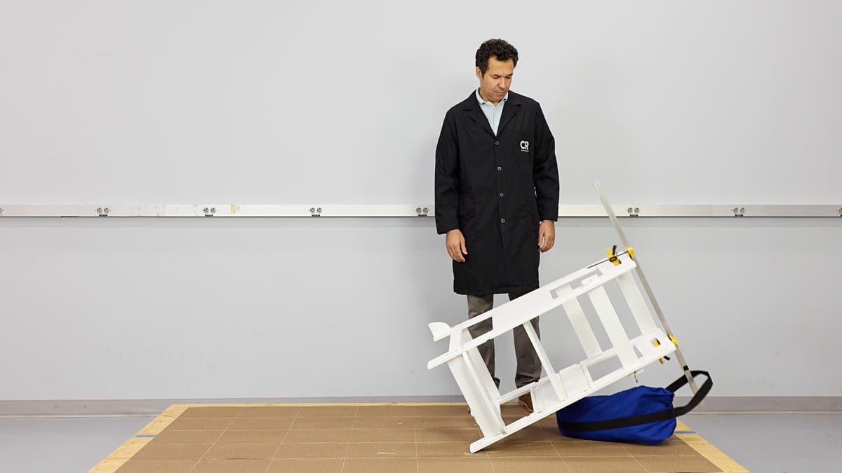 Juan Alberto Arguello Garcia Pertusa (Test Program Leader, Product Safety and Sustainability at Consumer Reports) performing a stability test on a Kitchen Toddler Tower with a 35 pound weight.