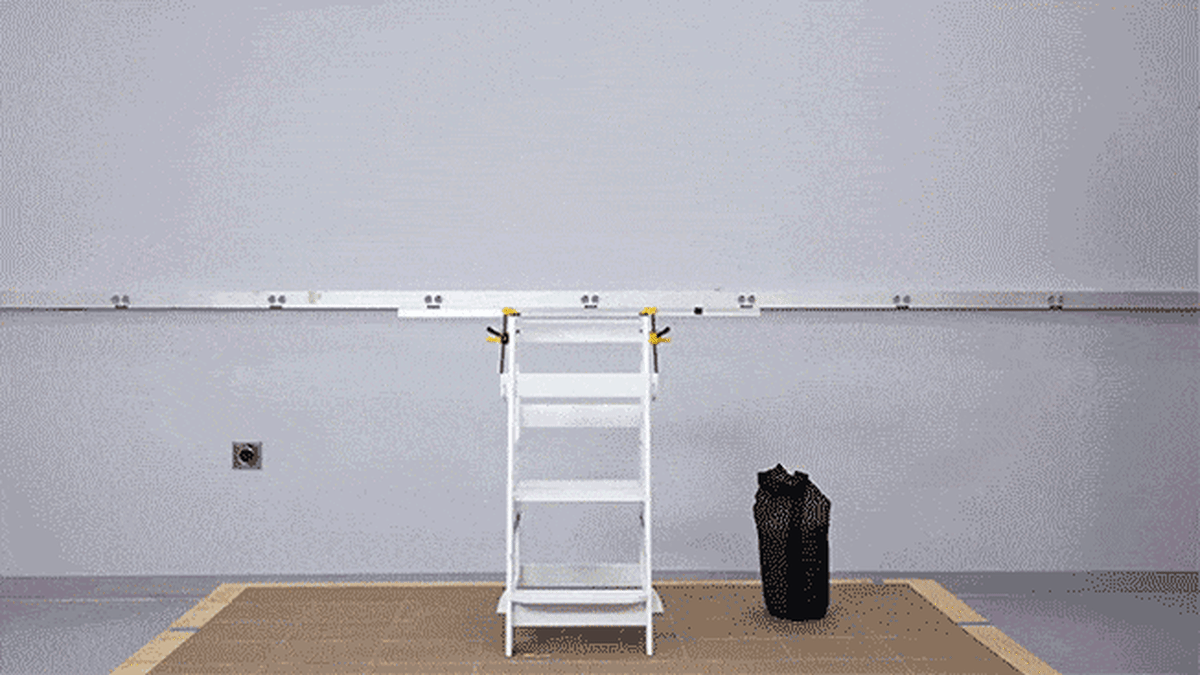 Juan Alberto Arguello Garcia Pertusa (Test Program Leader, Product Safety and Sustainability at Consumer Reports) performing a stability test on a Kitchen Toddler Tower with a 35 pound weight.