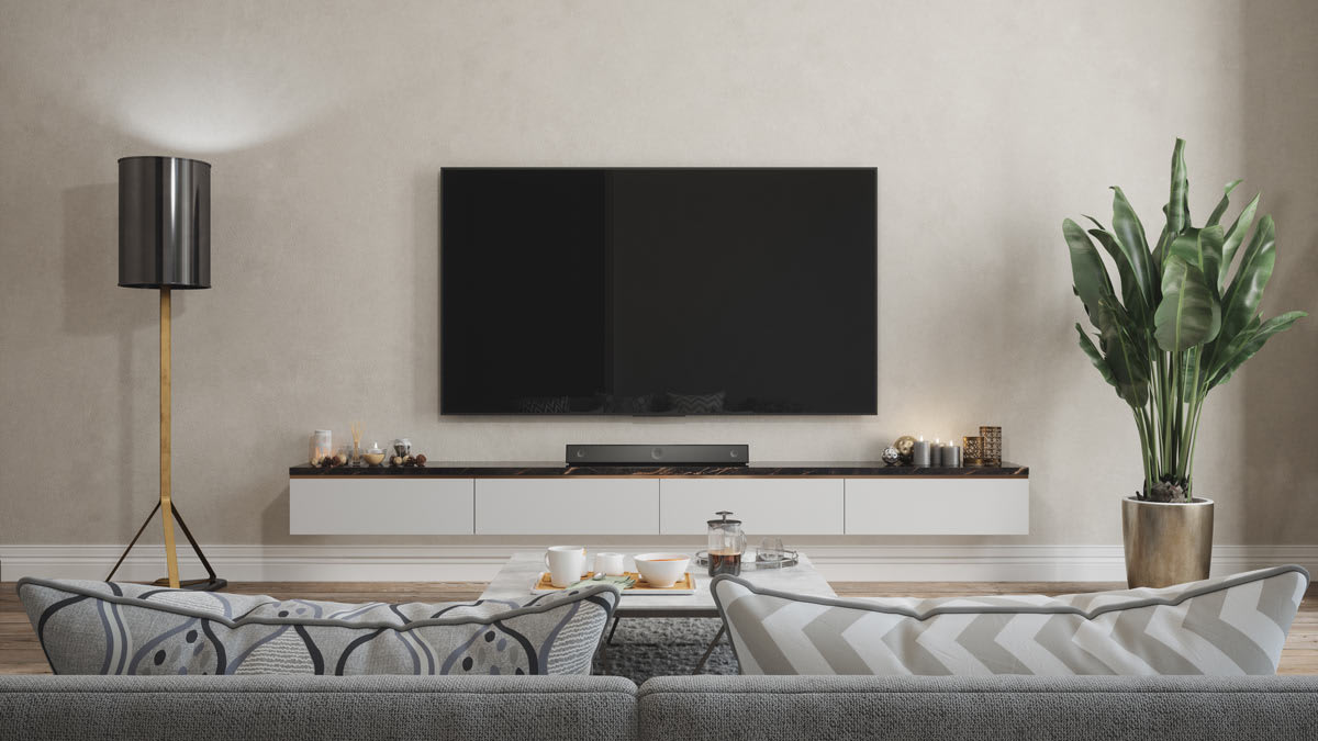A living room with a TV mounted to the wall.