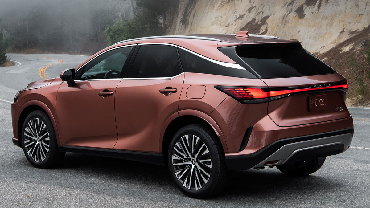 2026 Lexus RX Premium, shown from the rear, parked along a winding road.