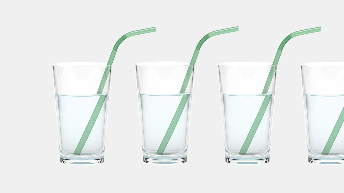 Four glasses of water with a straw.
