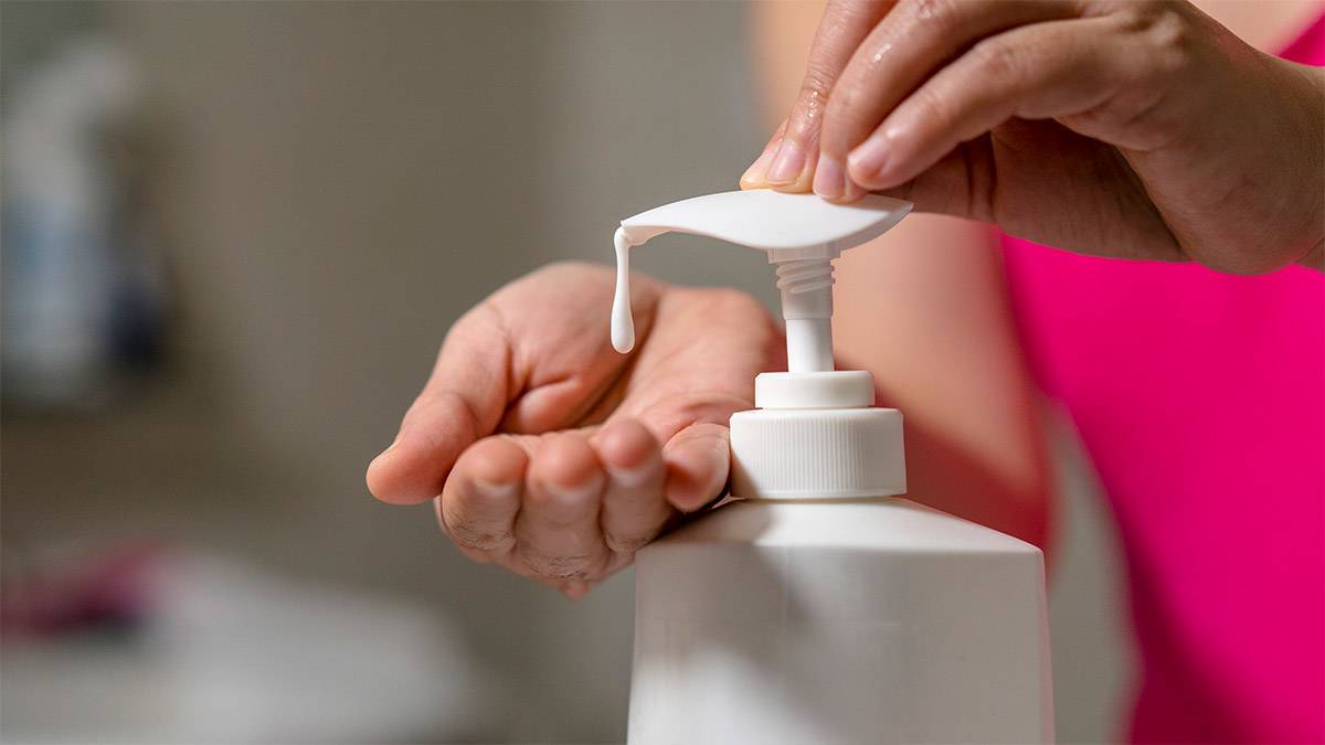 Woman pumping lotion from bottle